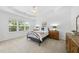 Cozy bedroom with tray ceiling, carpet flooring, and plenty of natural light at 1720 Laurel Park Pl, Cary, NC 27511