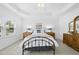 Bright bedroom showcasing a tray ceiling, neutral carpet, and plenty of natural light at 1720 Laurel Park Pl, Cary, NC 27511