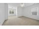 Bright bedroom with neutral carpet, ceiling fan and large windows offering natural light and open space at 1720 Laurel Park Pl, Cary, NC 27511
