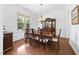 Elegant dining room with hardwood floors, a large window, and a classic hutch, ideal for Gathering gatherings at 1720 Laurel Park Pl, Cary, NC 27511
