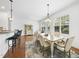Inviting dining area with a stylish rug, a modern chandelier, and a view of the backyard, perfect for Gathering meals at 1720 Laurel Park Pl, Cary, NC 27511