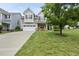 Charming two-story home featuring a well-manicured lawn and a two-car garage, enhancing curb appeal at 1720 Laurel Park Pl, Cary, NC 27511