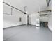 Spacious garage with sealed concrete flooring and overhead storage racks at 1720 Laurel Park Pl, Cary, NC 27511