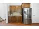 Kitchen with stainless steel refrigerator, granite countertops, and wood cabinetry at 1720 Laurel Park Pl, Cary, NC 27511