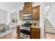 Kitchen area with stainless steel stove, granite countertops and wood cabinets at 1720 Laurel Park Pl, Cary, NC 27511