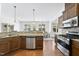Open-concept kitchen features stainless appliances, granite counters and plenty of cabinet space at 1720 Laurel Park Pl, Cary, NC 27511