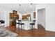 Beautiful kitchen with bar seating, stainless appliances, granite countertops, and hardwood floors at 1720 Laurel Park Pl, Cary, NC 27511