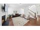 Spacious living room featuring a fireplace, hardwood floors, and a comfortable seating arrangement, great for relaxation at 1720 Laurel Park Pl, Cary, NC 27511