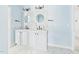 Bright bathroom featuring double sinks, round mirrors, and modern fixtures at 1728 Callandale Ave, Cary, NC 27518