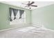 Bedroom with large window, ceiling fan and soft neutral carpet at 1728 Callandale Ave, Cary, NC 27518