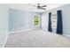 This is a light blue bedroom with two windows and a ceiling fan at 1728 Callandale Ave, Cary, NC 27518