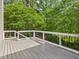 Spacious wooden deck with white railings overlooking a lush, green backyard at 1728 Callandale Ave, Cary, NC 27518