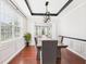 Dining room with hardwood floors and modern lighting, with large windows offering plenty of natural light at 1728 Callandale Ave, Cary, NC 27518