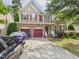 Two-story house featuring a brick and siding exterior, with a three car garage at 1728 Callandale Ave, Cary, NC 27518