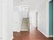 Hallway with hardwood floors leading to the staircase, showcasing the home's layout at 1728 Callandale Ave, Cary, NC 27518