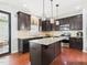 Spacious kitchen with granite countertops, stainless steel appliances, and a large island at 1728 Callandale Ave, Cary, NC 27518