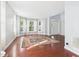 Bright living room with hardwood floors, large windows, and a colorful area rug at 1728 Callandale Ave, Cary, NC 27518