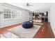 Bright living room with fireplace, hardwood floors, neutral walls, and large windows at 1728 Callandale Ave, Cary, NC 27518