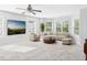 Bright living room boasting many windows and a ceiling fan at 1728 Callandale Ave, Cary, NC 27518