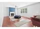 Bright living room with fireplace, hardwood floors, neutral walls, and large windows at 1728 Callandale Ave, Cary, NC 27518