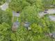 Aerial view of home surrounded by mature trees, a short distance from the road at 1905 Bivins St, Durham, NC 27707