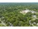 Lush green landscape surrounds homes in this aerial view of the community and nearby school at 1905 Bivins St, Durham, NC 27707