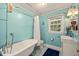 Bathroom with stylish clawfoot tub, blue tile floor, and modern fixtures at 1905 Bivins St, Durham, NC 27707