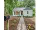 Charming home with a stone walkway, beautiful landscaping and flower boxes under the front windows at 1905 Bivins St, Durham, NC 27707
