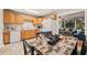 Kitchen with light oak cabinets, an adjacent dining area, and white appliances at 1905 Bivins St, Durham, NC 27707