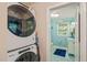 Laundry area with stacked washer and dryer that opens to an aqua painted bathroom at 1905 Bivins St, Durham, NC 27707