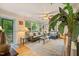 Inviting living room with hardwood floors, large windows, stylish furnishings and lots of plants at 1905 Bivins St, Durham, NC 27707