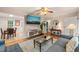 Cozy living room with hardwood floors, ceiling fan, large mounted TV and view to dining room at 1905 Bivins St, Durham, NC 27707