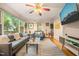 Spacious living room featuring hardwood floors, stylish furnishings, a ceiling fan, and ample lighting at 1905 Bivins St, Durham, NC 27707