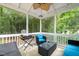 Inviting screened-in porch with outdoor seating and a view of the lush backyard at 1905 Bivins St, Durham, NC 27707