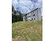 New townhome construction showing lawn, trees, and cloudy skies above gray toned modern units at 1912 Fishamble St # 20, Fuquay Varina, NC 27526