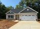 Charming one-story home features a two-car garage and a well-manicured lawn at 1995 Meadowview Dr, Graham, NC 27253