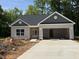 Charming, newly-constructed one story home featuring a two-car garage and neutral toned siding at 1995 Meadowview Dr, Graham, NC 27253
