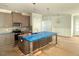 Bright, eat-in kitchen featuring an island with stainless steel appliances and modern finishes at 1995 Meadowview Dr, Graham, NC 27253