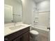 Clean and spacious bathroom with ample countertop space, neutral decor and bathtub with shower at 1998 Meadowview Dr, Graham, NC 27253