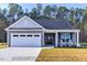 Charming single-story home featuring a two-car garage, covered entry, and well-manicured lawn at 1998 Meadowview Dr, Graham, NC 27253