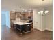 Bright kitchen with an island and wooden cabinets featuring stainless steel appliances and light fixtures at 1998 Meadowview Dr, Graham, NC 27253
