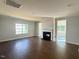 Open-concept living room with fireplace, large windows and hardwood floors throughout at 1998 Meadowview Dr, Graham, NC 27253