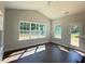 Open living room featuring large windows with natural light and hardwood floors at 1998 Meadowview Dr, Graham, NC 27253