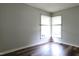 Bedroom featuring wood-look flooring, a window with blinds, and neutral paint throughout at 204 Kirkwood Dr, Chapel Hill, NC 27514