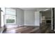 Bedroom featuring wood-look flooring and a door leading to an open space with a fireplace at 204 Kirkwood Dr, Chapel Hill, NC 27514