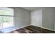 Bedroom featuring a closet, wood-look flooring, natural light, and a view of the outdoors at 204 Kirkwood Dr, Chapel Hill, NC 27514