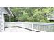 A peaceful wooden deck features white railing with a lush, green forest view at 204 Kirkwood Dr, Chapel Hill, NC 27514