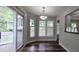 Bright dining area with sliding glass doors, plantation shutters, and modern lighting fixtures at 204 Kirkwood Dr, Chapel Hill, NC 27514