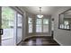 Cozy dining area with natural light, hardwood floors, and a view of the outdoor deck at 204 Kirkwood Dr, Chapel Hill, NC 27514