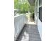 A gray, wood-floored entryway features white railing and a quaint stone pathway at 204 Kirkwood Dr, Chapel Hill, NC 27514
